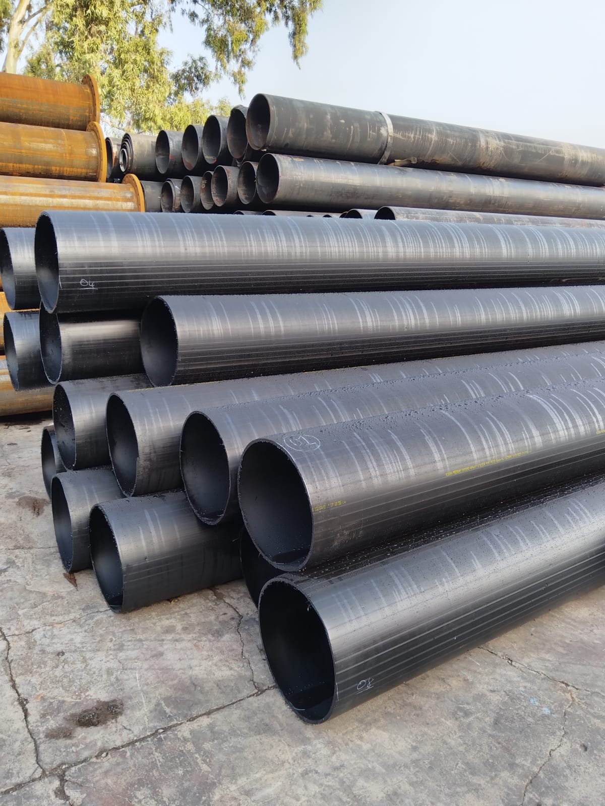 Stacked HDPE liner pipe stocked at Wetpipe for lined steel systems