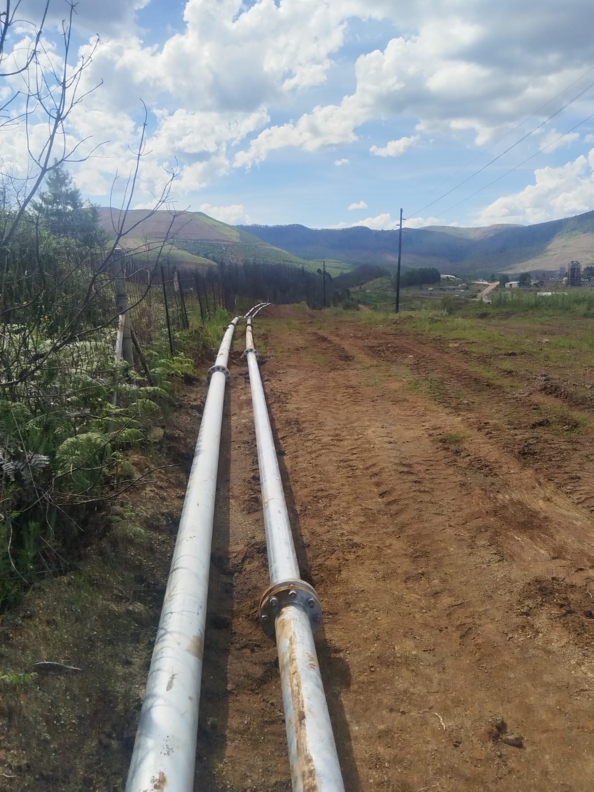 Twin overland slurry pipelines installed across open mining terrain
